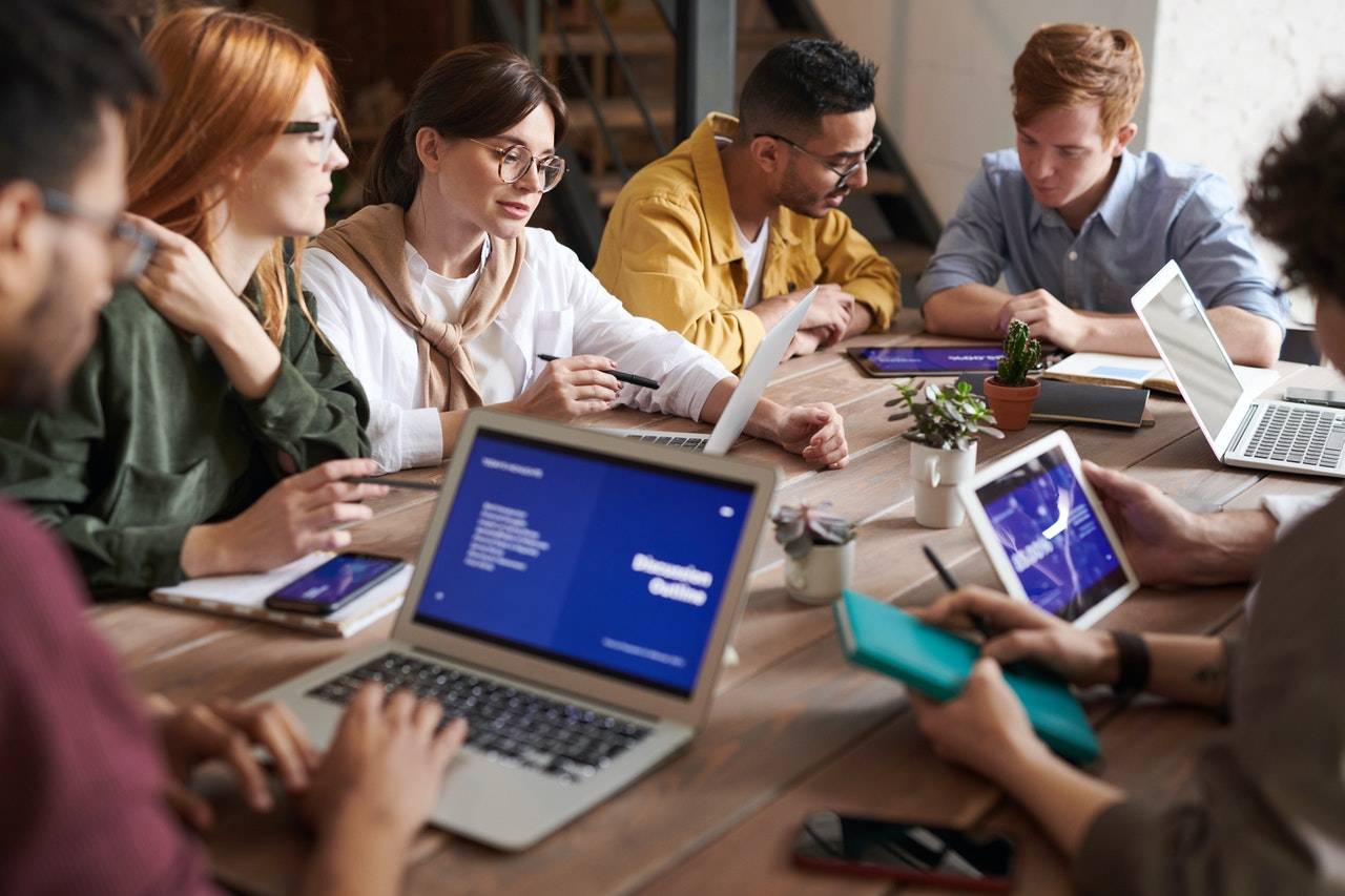 people discussing at a table - GIBX DEX