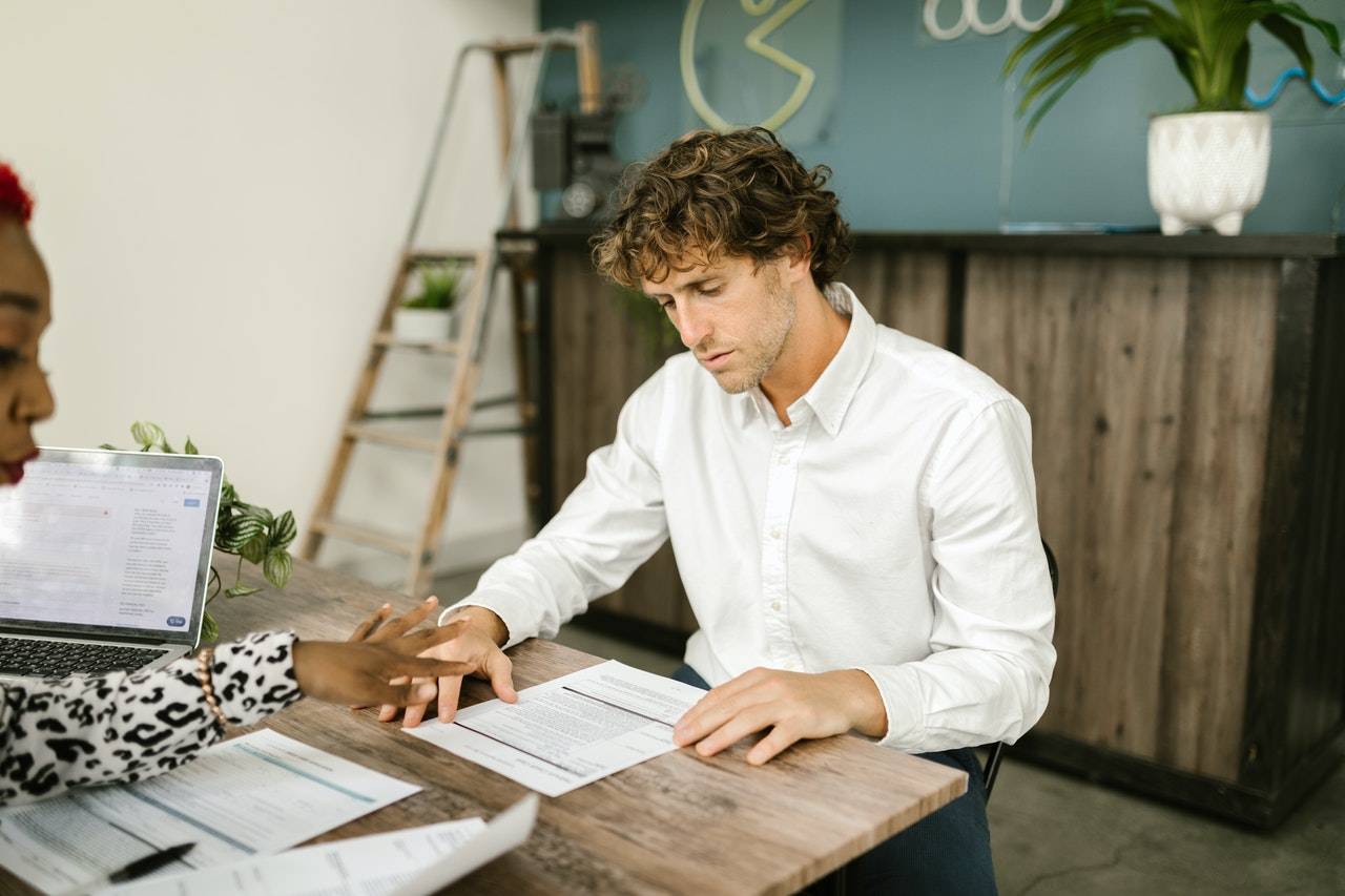 a man sitting at a table - GIBX MT5